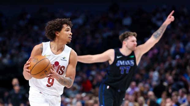 Dec 27, 2023; Dallas, Texas, USA; Cleveland Cavaliers guard Craig Porter (9) looks to score as Dallas Mavericks guard Luka Doncic (77) reacts during the first quarter at American Airlines Center.